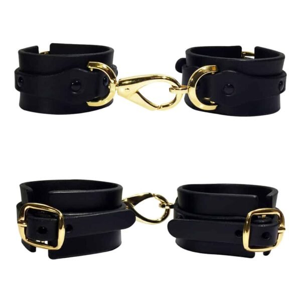 Black leather handcuffs with details and gold ELF ZHOU strap at Brigade Mondaine