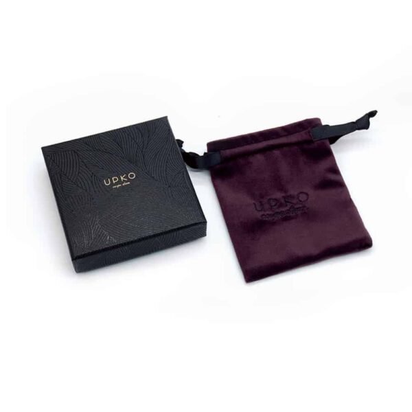 Little black Upko box with graffiti with its little pocket in dark burgundy velvet and embroidered with black thread of the UPKO logo for the limited editions UPKO X Brigade Mondaine on a white background available at Brigade Mondaine