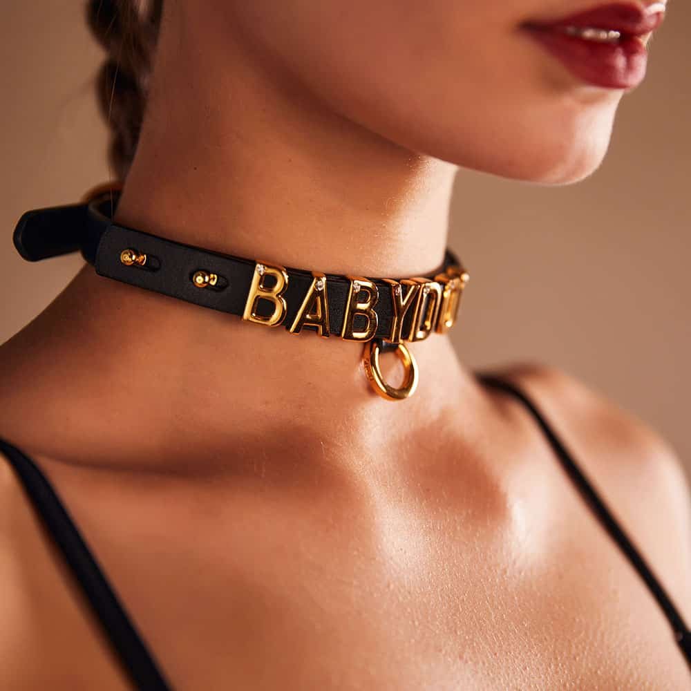 Choker resulting from the collaboration between Brigade Mondaine and Upko. The base of the choker is made from Italian leather and each letter is plated with 24 carat gold and encrusted with a crystal each.
