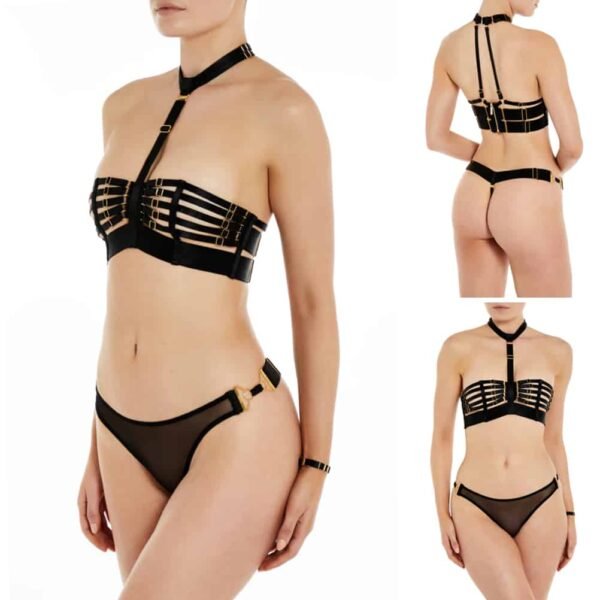 Black thong collection Ula from the brand Bordelle. On the front, a transparent illusion mesh covers the intimate parts and the lower stomach. On the hips, two gold-plated jewels join the front and back pieces. At the back, a wide elastic with gold-plated adjustments covers the top of the buttocks. The string is a thin elastic.