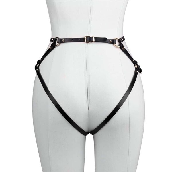 Harness briefs Doris in black leather by Elif Domanic. These panties are made of a triangle for the lower abdomen which is connected to the waist by a strap. At the back two straps in the shape of panties maintain the buttocks. The whole is connected by golden brass rings and some nails on both sides of the product. The harness is attached to the lower back with a thin gold buckle.