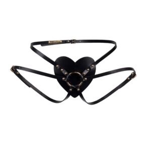 Harness black leather from Elif Domanic. This harness has an elegant leather heart placed at the level of the lower abdomen with in its center a golden brass ring which gathers the straps placed on the lower back and for the turns of thighs. Fine buckles and a few gold coloured studs are placed on both sides of the product.
