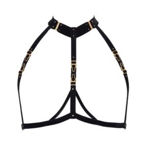 Back of the Verene harness by Hervé by Celine Marie. The harness is made of soft and fine black velvet elastics and 24 carat gold plated adjustments and hooks. The front of the harness has three elastics placed on either side of the chest. The elastic at the neck is much thicker with studs. Two thin elastics are placed between the chest and the waist. The harness is attached to the neck with a gold hook and contains a back strap.