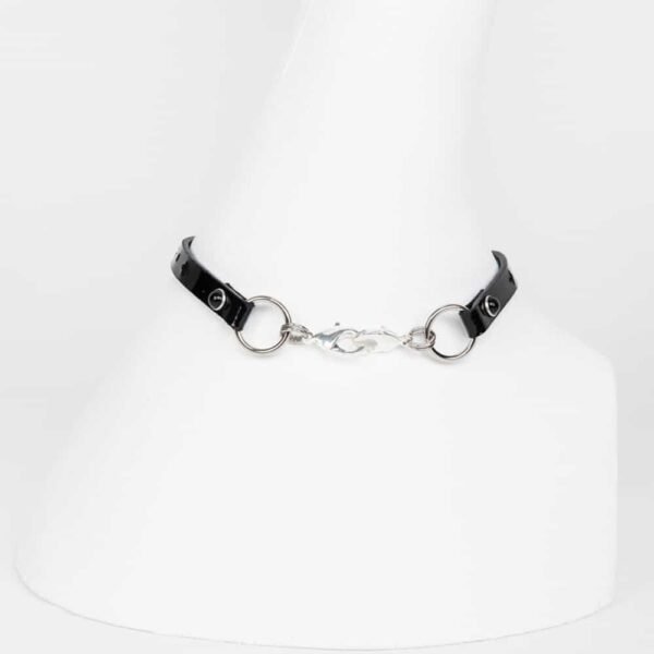 Laser-cut leather necklace glossy black patent leather, crystal rivets edged with black pearl silver and silver-plated metal trim, embossed brand logo.