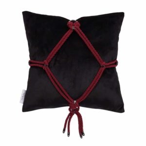 This soft velvet pillow with a Shibari ornament tied on the front - the classic "Kikkou" diamond pattern. Executed in the same manner as all other Figure of A products, with gunmetal hardware and dangling spiked rope ends, it's a unique gift that looks great placed on a sofa or bed. This pillow is available at Brigade Mondaine.