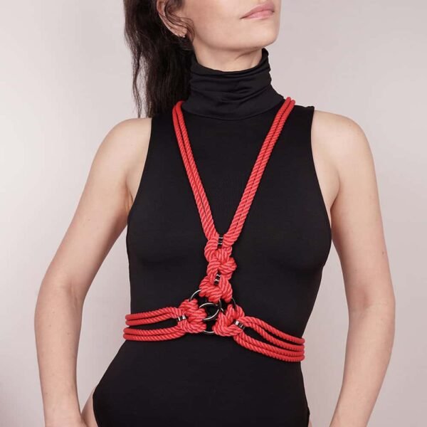 San Harness' is tightly bound with polyester rope, it is finished with zinc alloy and brass hardware. Crossing the chest with two lines crossing the body, it features a decorative centerpiece with three intertwined metal rings. Attached to the neck and natural waist by snap rings, 'San' is like a harness belt that frames the body with elegance. A clasp and chain at the back can be adjusted for a custom fit.