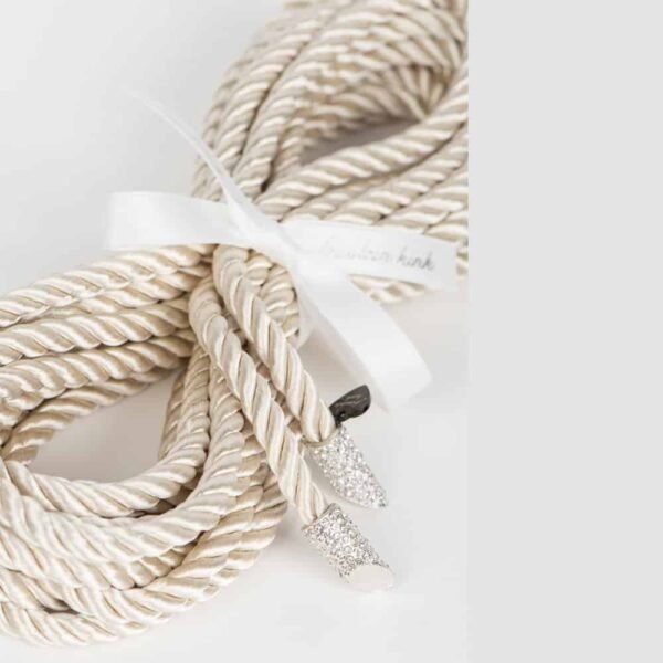 Shibari Rope from the Original Sin Bianco collection by Fraulein Kink on Brigade Mondaine. Entirely handcrafted and made to order in Berlin, in the brand's workshops, from silk rope; The Shibari Rope Bianco is an extraordinary luxury bondage accessory. Add some sexy sparkle to your boudoir with the 5 meter long bondage lasso with white and silver crystal tip. Transform the lasso into a belt or harness to add a special fetish touch to your favorite outfit.