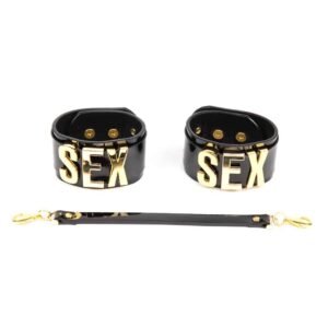 * Black patent leather straps * Gold sliding letters SEX * Gold brass double cap rivet and accents * Removable leather handcuff leash * Adjustable cuff size between 19.5 and 21.5 cm